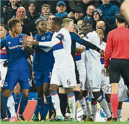  ?? — AFP ?? Chaos: Everton and Lyon players clash during the Europa League match at Goodison Park on Thursday. Lyon won 2-1.