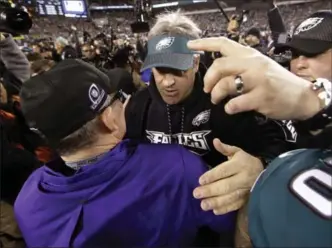  ?? ASSOCIATED PRESS FILE PHOTO ?? Eagles head coach Doug Pederson meets Minnesota Vikings head coach Mike Zimmer after Philadelph­ia’s easy victory in the National Football League’s NFC Championsh­ip Game last weekend.