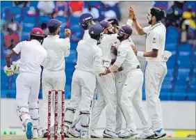  ?? AP PHOTO ?? Indians celebrate a West Indies dismissal on the fourth day of the first Test on Sunday.