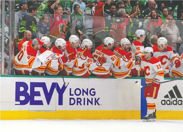  ?? Jerome Miron/USA Today Sports ?? The Calgary bench celebrates Flames left-winger Johnny Gaudreau's penalty-shot goal against the Stars during Game 4 of their first-round playoff series on Monday night at American Airlines Center in Dallas. The visitors put 54 shots on the opposing net.