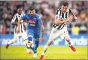  ??  ?? Napoli's Elseid Hysaj (L) fights for the ball with Juventus' Mario Mandzukic during their match at the Allianz Stadium in Turin.