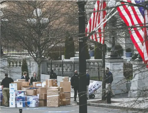  ?? ERIN SCOTT / REUTERS ?? Workers move boxes out of the Eisenhower Executive Office Building on the White House grounds on Thursday as White House staff were busy clearing their offices for next week’s presidenti­al changeover.