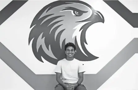  ?? AMANDA ROSSMANN/CINCINNATI ENQUIRER ?? Bijin Basu, a senior at Cincinnati Country Day School, is part of an Equity, Diversity and Inclusion committee at the Cincinnati Country Day School and had a lot to say on making the school a more inclusive place amid the school’s mascot change. He is photograph­ed with the new Nighthawks logo at Cincinnati Country Day School on Monday.
