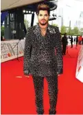  ??  ?? In a handout picture released by the Brit Awards US singer-songwriter Adam Lambert poses on the red carpet on arrival for the BRIT Awards 2021.