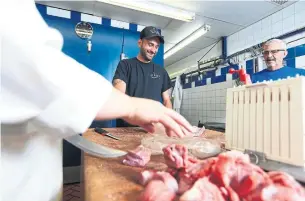  ?? RENÉ JOHNSTON TORONTO STAR ?? George Laganas, centre, was accepted to teachers’ college when he finished university, but he says that working with his father at Ellas Meat Market was all about putting “happiness” first.