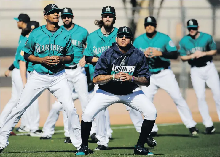  ?? — AP FILES ?? Seattle Mariners starting pitcher Felix Hernandez, centre, stretches with teammates during a spring training practice in Peoria, Ariz., last week.