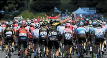  ?? PHOTOS BY PETER DEJONG — THE ASSOCIATED PRESS ?? The pack rides during the fourth stage of the Tour de France cycling race over 121 miles with start in La Baule and finish in Sarzeau, France, Tuesday, July 10, 2018.