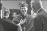  ?? CHARLIE LEIGHT/THE ARIZONA REPUBLIC/AP ?? BISHOP THOMAS J. OLMSTED talks with parishione­rs at St. Catherine of Sienna, on June 16, 2014, in Phoenix.