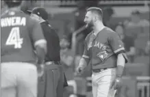  ?? JOHN BAZEMORE, THE ASSOCIATED PRESS ?? Kevin Pillar, right, looks on as both benches empty onto the field after he exchanged words with Braves pitcher Jason Motte in the seventh inning in Atlanta on Wednesday night. Pillar has been suspended two games for yelling an anti-gay slur.