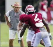  ?? VASHA HUNT — AL.COM VIA AP ?? Alabama coach Nick Saban works with his players during NCAA college football practice Aug. 16in Tuscaloosa, Ala.