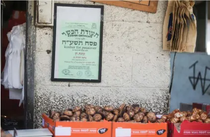  ?? (Marc Israel Sellem/The Jerusalem Post) ?? A ‘KOSHER FOR Passover’ poster at a stand in Mahaneh Yehuda in Jerusalem.