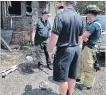  ?? BILL SAWCHUK TORSTAR FILE PHOTO ?? Todd Menard carries a python he rescued after a fire on Oakdale Avenue last week.