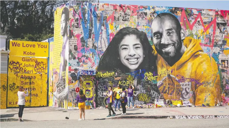  ?? Kyle Grilot / REUTERS Files ?? Fans gather around a mural of NBA great Kobe Bryant and his daughter Gianna Bryant at a public memorial at the Staples Center in Los Angeles.