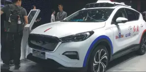  ?? LI FUSHENG / CHINA DAILY ?? An autonomous vehicle with Baidu’s Apollo system at the Guangzhou auto show in November. The Apollo has attracted more than 100 partners including Chinese and internatio­nal carmakers.