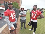  ??  ?? Atlanta Falcons linebacker Deion Jones (45) shares a laugh with safety Damontae Kazee (27) after practice.