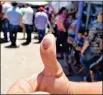  ??  ?? A VOTER SHOWS AN INK-STAINED THUMB showing he voted Sunday in the elections in San Luis Rio Colorado, Son.