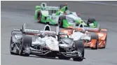  ??  ?? Will Power leads the field into a turn during the Grand Prix of Indianapol­is on the Indianapol­is Motor Speedway road course on Saturday. Power won the race from the pole.