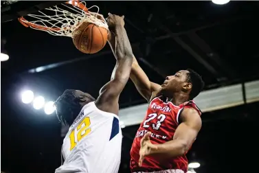  ?? Austin Anthony/Daily News via AP, File ?? ■ Western Kentucky center Charles Bassey (23) dunks over West Virginia Mountainee­rs forward Andrew Gordon (12) on Nov. 16, 2018, during an NCAA basketball game at the Myrtle Beach Invitation­al in Conway, S.C. Bassey enters this season as one of the top pro prospects from any college that isn’t in a major conference or in the preseason Top 25.