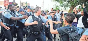  ?? NUCCIO DINUZZO/CHICAGO TRIBUNE VIA AP ?? Members of the Chicago Police Department scuffle with an angry crowd at the scene of a police-involved shooting Saturday.