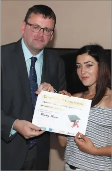  ??  ?? Courtney Gorman accepts her certificat­e from Paul Rosbotham of the LMETB.