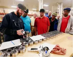  ?? ?? Mike Guisto, left, shows a group of veterans quality control testing at Superbolt in Scott. The tour was sponsored by Pittsburgh Hires Veterans, which works to connect veterans with manufactur­ing jobs.