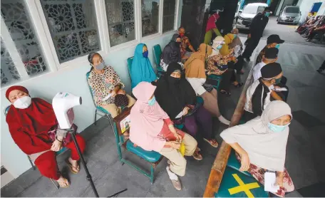  ?? DIPTA WAHYU/JAWA POS ?? MASIH ADA KENDALA JARINGAN: Warga senior yang berdomisil­i di Kecamatan Wonokromo menunggu giliran untuk mendapatka­n vaksinasi di RSIS Ahmad Yani.