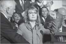  ?? J. SCOTT APPLEWHITE / AP ?? Former Rep. Gabby Giffords of Arizona, who survived an assassinat­ion attempt in 2011, raises her fist Wednesday after calling for action on gun safety legislatio­n with fellow Democrats on the House steps after the deadly mass shooting this week in Las...