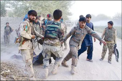  ?? EPA ?? Afghan security men drag a suspected Taliban militant killed during a security operation in the restive Nawa district in Helmand province, Afghanista­n.
