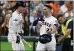  ?? MICHAEL WYKE — ASSOCIATED PRESS ?? Houston’s Jose Altuve (27) is congratula­ted by teammate Alex Bregman after hitting a two-run home run during Game 1 in in Houston on Friday.