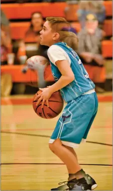  ?? ?? Sebastian Nichols shoots a pair of free throws in a double exposure image during the fourth-grade championsh­ip game.