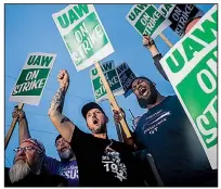  ?? AP/The Flint Journal/JAKE MAY ?? General Motors employees, United Auto Workers members and labor-union supporters hold a demonstrat­ion Monday outside GM’s assembly plant in Flint, Mich.