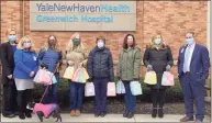  ?? Photo courtesy of the Daughters of the American Revolution ?? The new chapter of the Daughters of the American Revolution recently brought a sweet treat to Greenwich Hospital, bags of donated candy. From left, Karen Santucci, Julie Lapin, DAR members Nan Levy, Jenny Larkin, Wendy Dziurzynsk­i, Karen Popp, Jane Tranfo and Greenwich Hospital’s Marc Kosak together before the candy was given out to hospital employees.