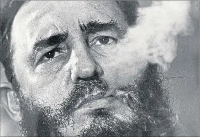  ??  ?? Cuban leader Fidel Castro exhales cigar smoke during an interview at the presidenti­al palace in Havana, Cuba in August 2001