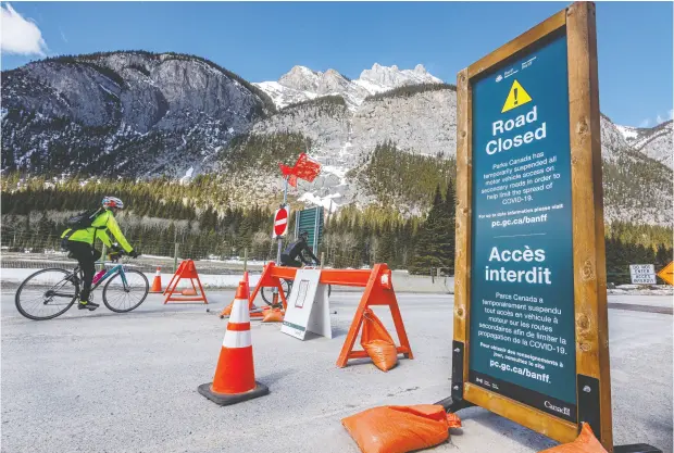  ?? Mike Drew / Postmedia News ?? A road to Lake Minnewanka is closed to vehicles in Banff National Park last month. About 90 per cent of Banff ’s economy is based on tourism.