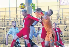  ??  ?? Keeper’s ball
Viljami Sinisalo gets a good punch on another cross ball