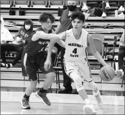  ?? Photo by Alexis Meeks ?? Magnet Cove’s Bo Battingly dribbles past Ouachita’s Colton Braswell during their game on Monday. Battingly led the Jr. Panthers in scoring with 27 points. His efforts helped lead the Jr. Panthers to victory in overtime against the Jr. Warriors.