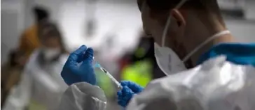  ?? /AP ?? SPAIN. A health worker prepares a vaccine for members of Madrid Emergency Service (SUMMA) in Madrid, Spain, Tuesday, Jan. 12, 2021.