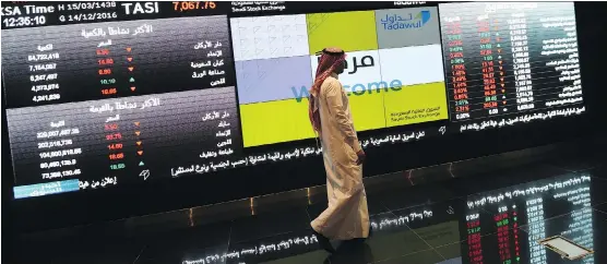  ?? AYEZ NURELDINE/AFP/GETTY IMAGES FILES ?? A Saudi investor monitors the Saudi Stock Exchange, or Tadawul, in Riyadh. Saudi Arabia’s diplomatic dust-up with Canada has heightened the sense of risk in the Saudi investment climate and is certain to scare even more capital away, writes Karen Young.