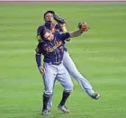  ?? KAMIL KRZACZYNSK­I / USA TODAY SPORTS ?? Milwaukee Brewers second baseman Eric Sogard, front, collides with shortstop Orlando Arcia after catching a fly ball during the eighth.