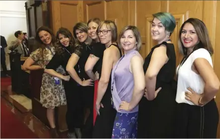  ?? THE CANADIAN PRESS ?? From front, Bhinder Sajan, Shannon Waters, Liza Yuzda, Justine Hunter, Jen Holmwood, Katie DeRosa, Tanya Fletcher and Kylie Stanton pose for a photo at the B.C. Legislatur­e in Victoria Thursday. A dress code debate at the legislatur­e has prompted some female staff and journalist­s to roll up their sleeves in protest.