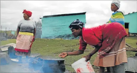  ??  ?? HANDS ON: Women cook and prepare for traditiona­l circumcisi­on ceremonies while men are responsibl­e for the customary practices and the decisions required in the process