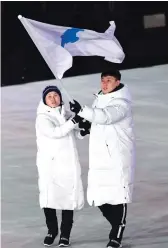  ?? AFP ?? Unified Korea’s flagbearer­s Hwang Chung Gum, left, and Won Yun-Jong lead the delegation parade into the stadium.