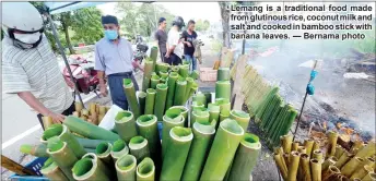  ??  ?? Lemang is a traditiona­l food made from glutinous rice, coconut milk and salt and cooked in bamboo stick with banana leavesK — Bernama photo