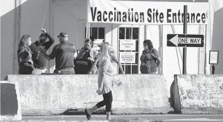  ?? JOE CAVARETTA/SOUTH FLORIDA SUN SENTINEL ?? A client leaves the Palm Beach County Health Department COVID-19 vaccinatio­n site at the South Florida Fairground­s on Feb. 10. The newly opened site is walkup and by appointmen­t only.
