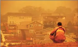  ?? JUSTIN SULLIVAN/GETTY IMAGES ?? A firefighte­r looks towards a home that was destroyed by the Glass Incident Fire on Sunday in Santa Rosa. The fast-moving Glass Incident Fire has burned over 11,000 acres in Sonoma and Napa counties. The fire is zero percent contained.