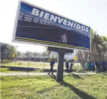  ?? AP PHOTO/JUAN CARLOS HERNANDEZ ?? A Goodyear billboard emblazoned with the Spanish word for welcome is posted near a plant entrance where workers arrived to find the plant is no longer in operation. In Los Guayabos, Venezuela, on Monday. U.S. tire company Goodyear announced it will no longer continue production in Venezuela as economic conditions in the South American nation continue to deteriorat­e.