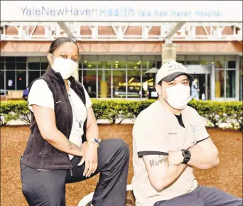  ?? Peter Hvizdak / Hearst Connecticu­t Media ?? Tara Smith, left, and Cesar Vazquez, members of the Environmen­tal Services team at Yale New Haven Hospital, clean rooms and common areas where COVID-19 patients are being treated.