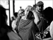  ?? GREGORY BULL/AP ?? A woman waits in line for donated goods at a distributi­on center in Pasadena, Texas. After Harvey, many Texas residents saw their life situations go from bad to worse.
