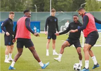  ?? AP ?? England’s Raheem Sterling (third right) challenges teammate Ruben Loftus-Cheek (second right) for the ball during a training session yesterday.