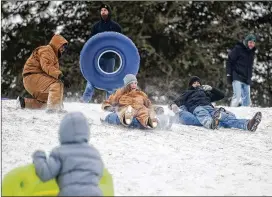  ?? SARAH A. MILLER / TYLER MORNING TELEGRAPH ?? Emma Carver, 12, sleds down a snowy hill Tuesday on the campus of the University of Texas at Tyler. A winter storm closed schools and made roads hazardous in East Texas as well as Houston and Central Texas.